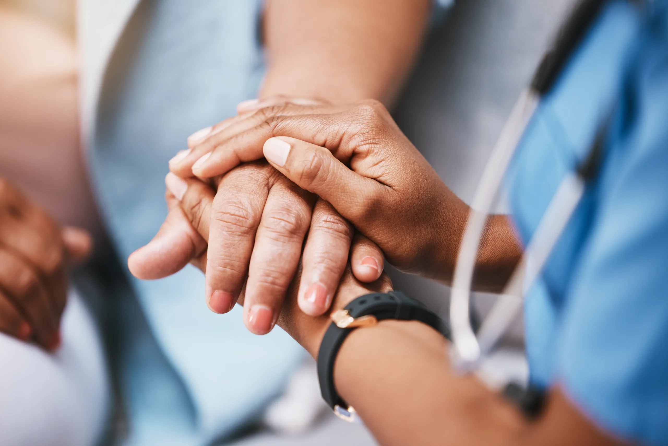 Nurse holding patient's hand